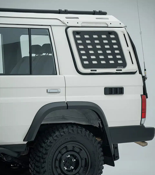 White off-road vehicle with a roof rack and additional storage compartment on a gray background