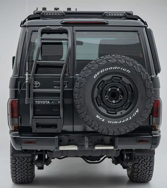 Back view of a Toyota vehicle with a spare tire mounted on a gray background