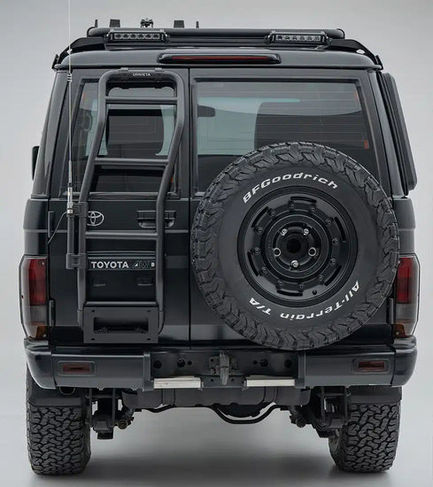 Back view of a Toyota vehicle with a spare tire mounted on a gray background