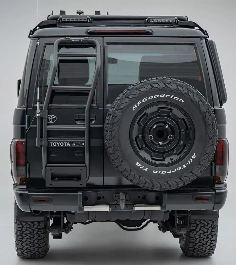 Back view of a Toyota vehicle with a spare tire mounted on a gray background