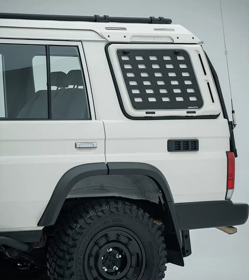 White off-road vehicle with a roof rack and additional storage compartment on a gray background