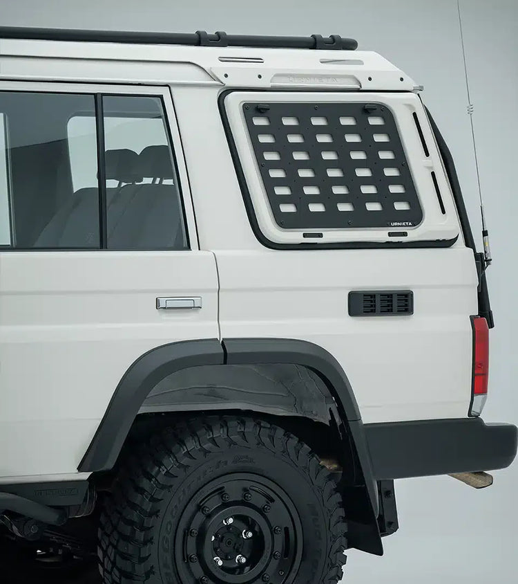 White off-road vehicle with a roof rack and additional storage compartment on a gray background